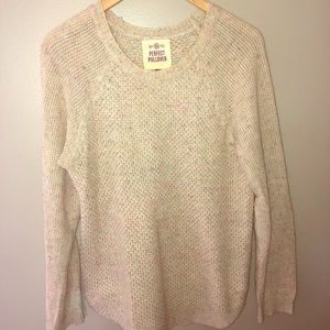 Cream sweater with bits of color throughout.